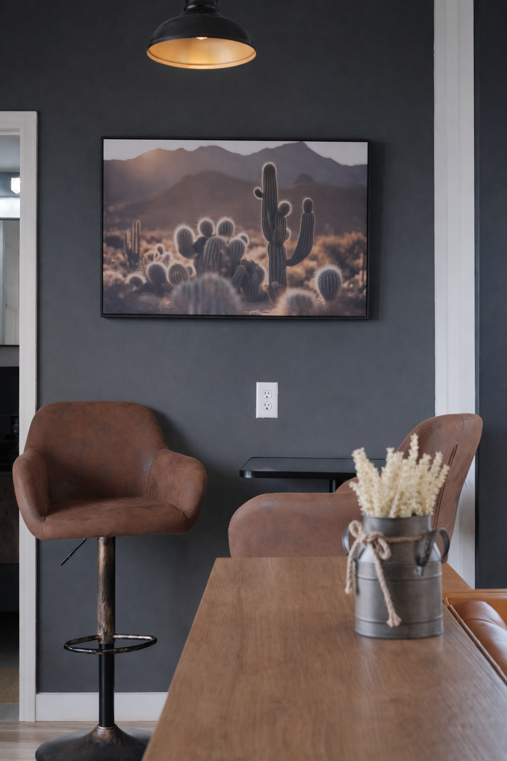 Dining area with leather stools and desert print